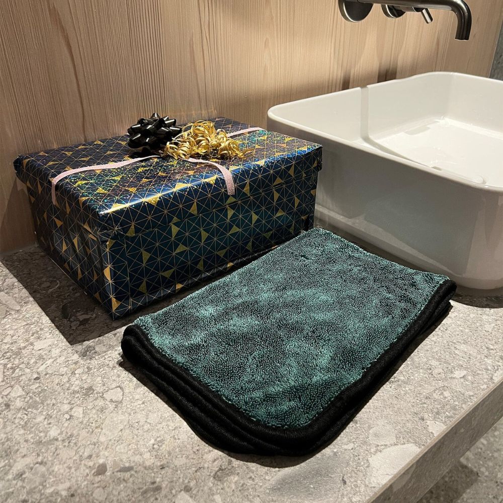 Large drying towel soaking water from shower walls and floors