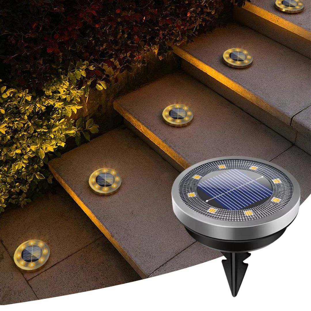 NightPath solar ground lights warm white illuminating garden pathway at night