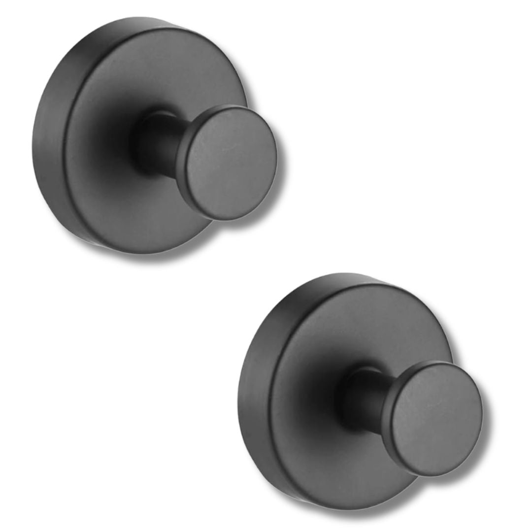 Stainless steel wall hooks holding heavy bathrobe on smooth marble bathroom surface