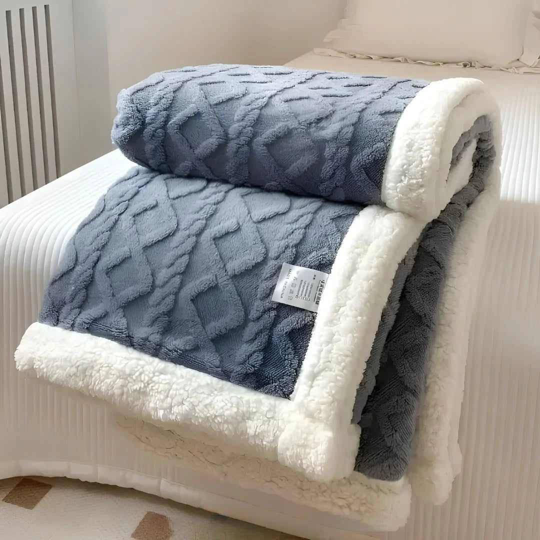 CozyCloud fleece throw blanket folded neatly on end of bed for styling