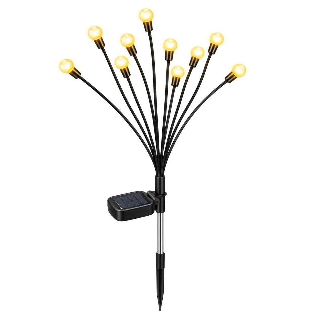 Solar garden lights with firefly LED stems pushed into soil along pathway