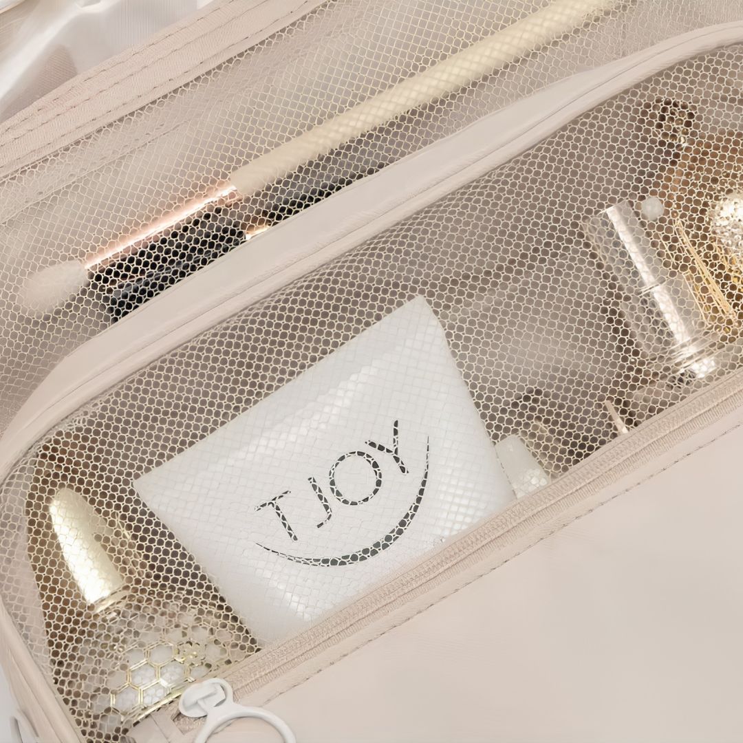 Travel toiletry bag hanging on hotel bathroom door hook