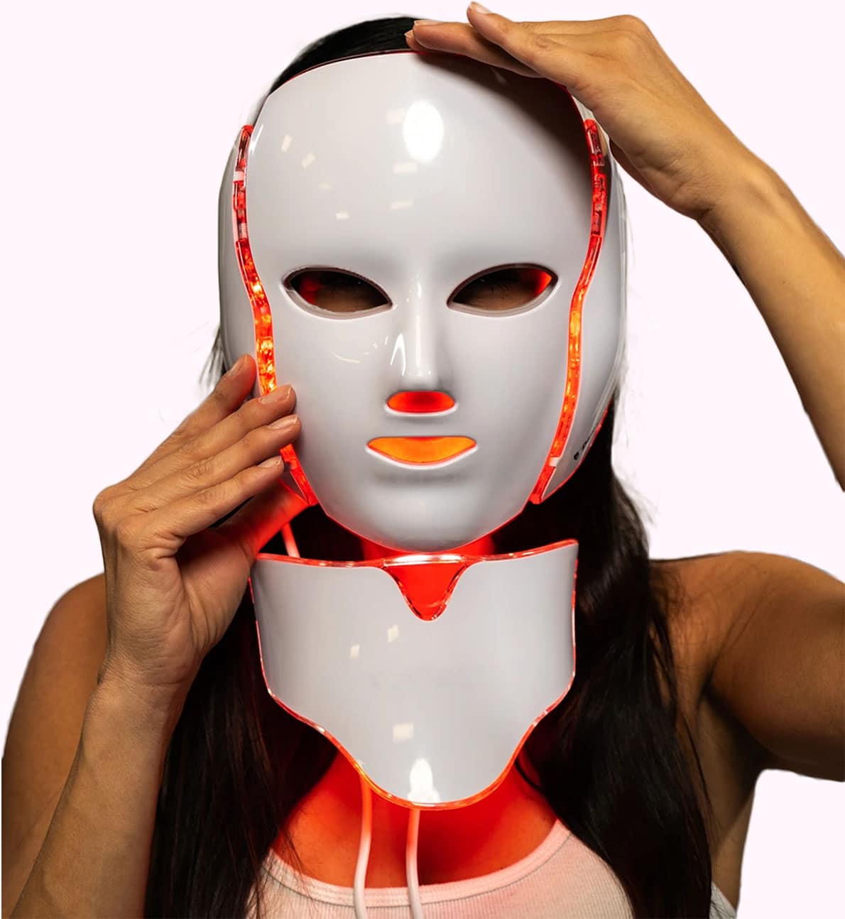 Woman using LuxeGlow 7-in-1 light therapy mask at home


